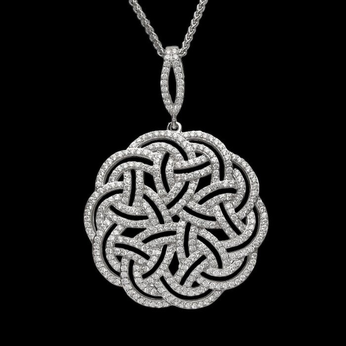 Sterling silver interlaced Celtic Knot pendant with sparkling CZ stones, statement heritage jewelry, on black background. 