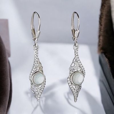 Sterling silver drop earrings featuring Mother of Pearl with Celtic knotwork design, celebrating Irish heritage.