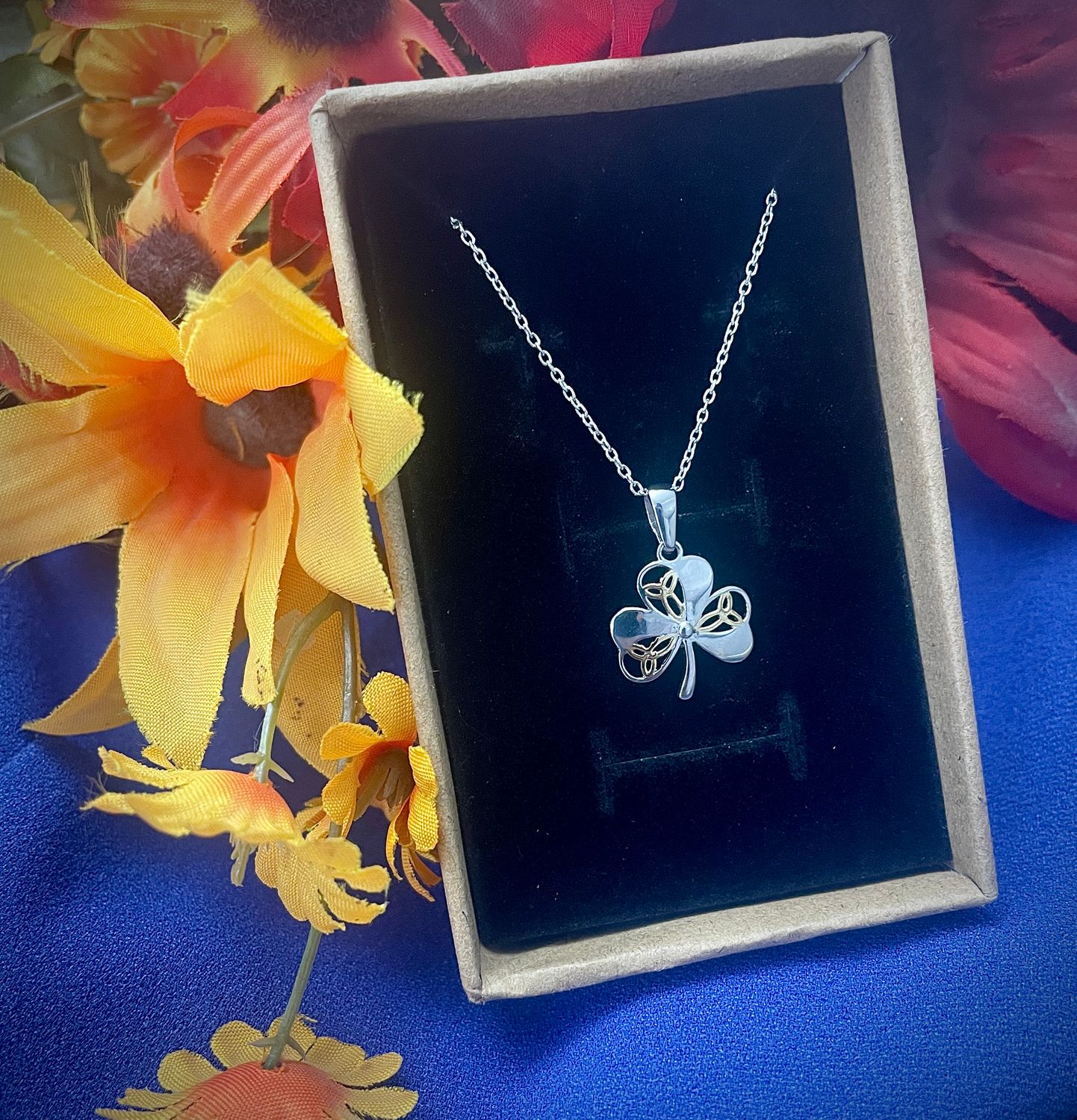 Sterling silver Shamrock pendant featuring three yellow gold plated Trinity knots, inspired by Irish heritage, in jewelry box