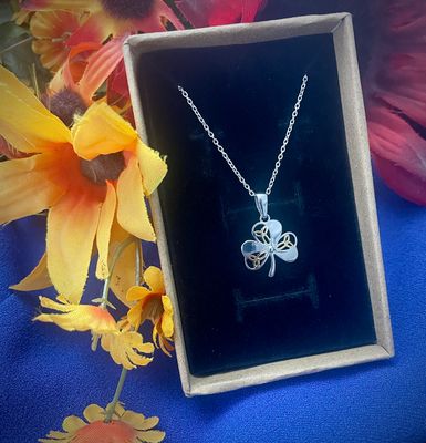 Sterling silver Shamrock pendant featuring three yellow gold plated Trinity knots, inspired by Irish heritage, in jewelry box