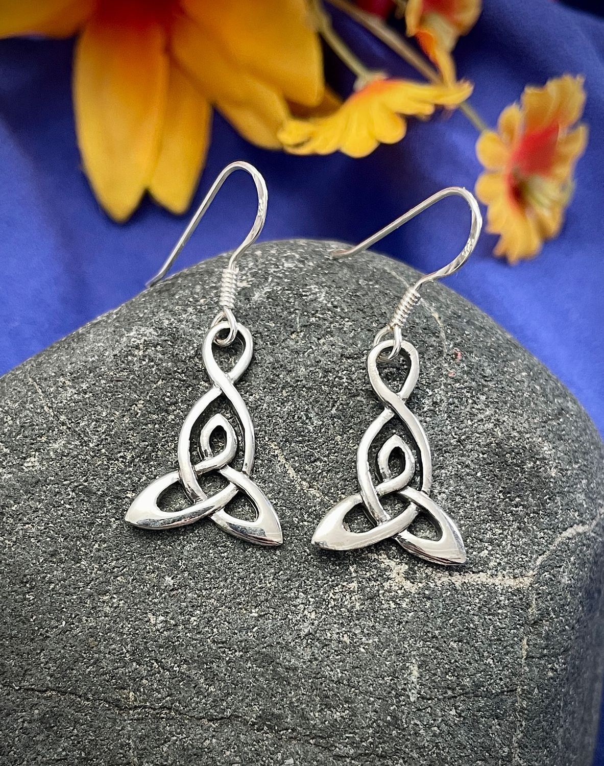 Motherhood Trinity Knot Earrings Sterling silver Celtic Motherhood Knot earrings on stone, symbolizing the eternal bond between mother and child.