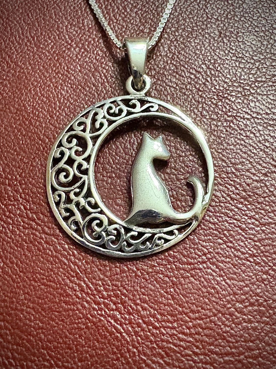 Sterling silver Celtic moon pendant with intricate knotwork and a cat design, perfect for cat lovers or a memorial gift.