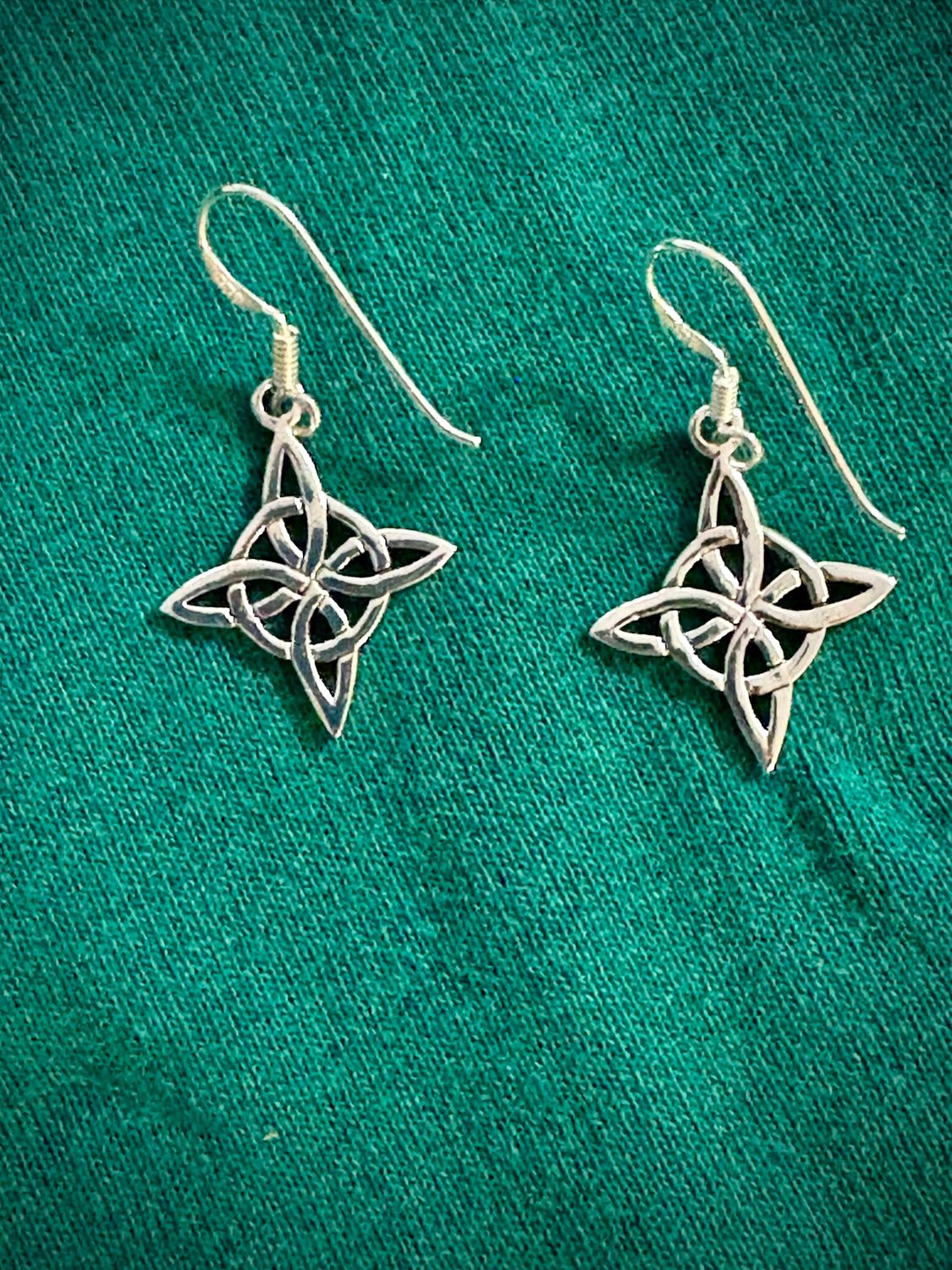 Witch's Knot Hexefus Earrings Sterling Silver Witch's Knot Hexefus Earrings on Green Fabric.