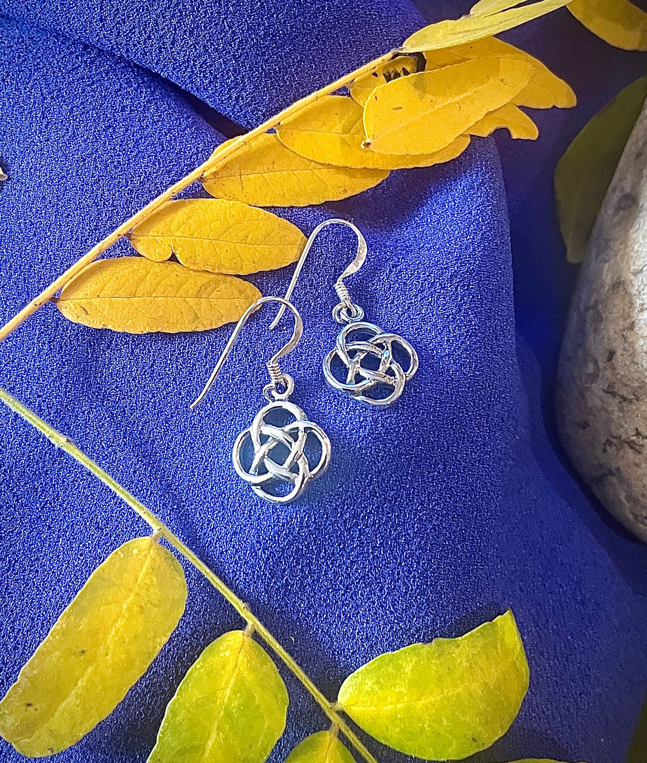 Celtic Knot Earrings - Beth Elegant sterling silver earrings with classic Celtic knot pattern, representing love, loyalty, and eternity. On purple fabric
