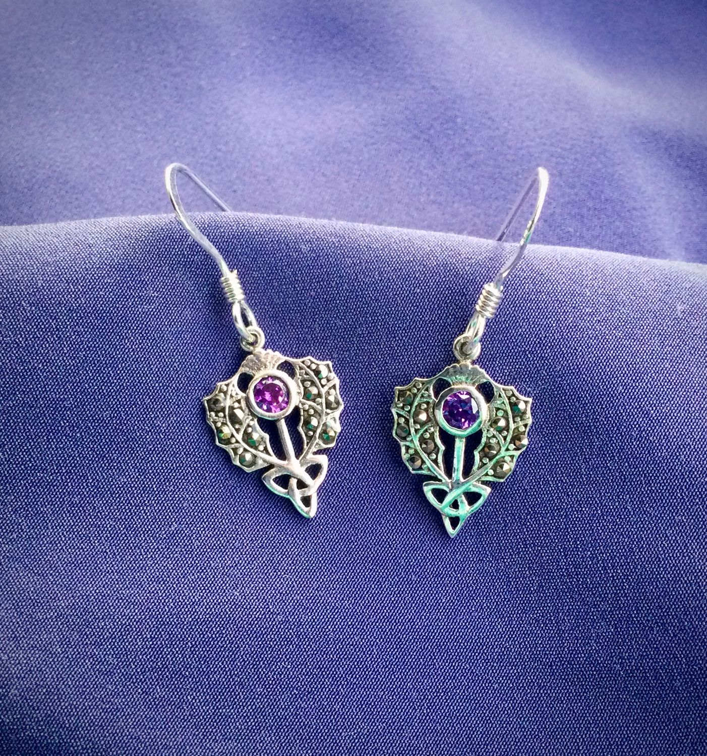 Silver and Marcasite Thistle Drop Earrings Sterling silver Scottish thistle drop earrings with trinity knot design and central marcasite stone.